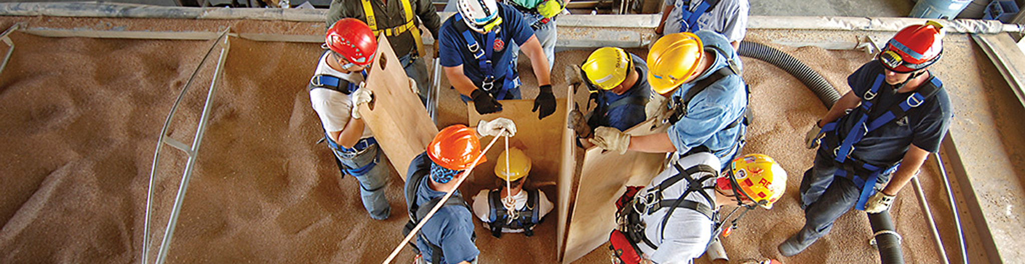Firefighters performing a grain bin safety rescue exercise