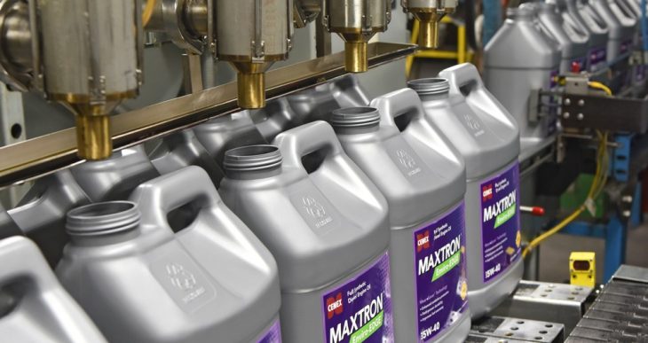 Cenex Maxtron lubricant jugs on a fill line