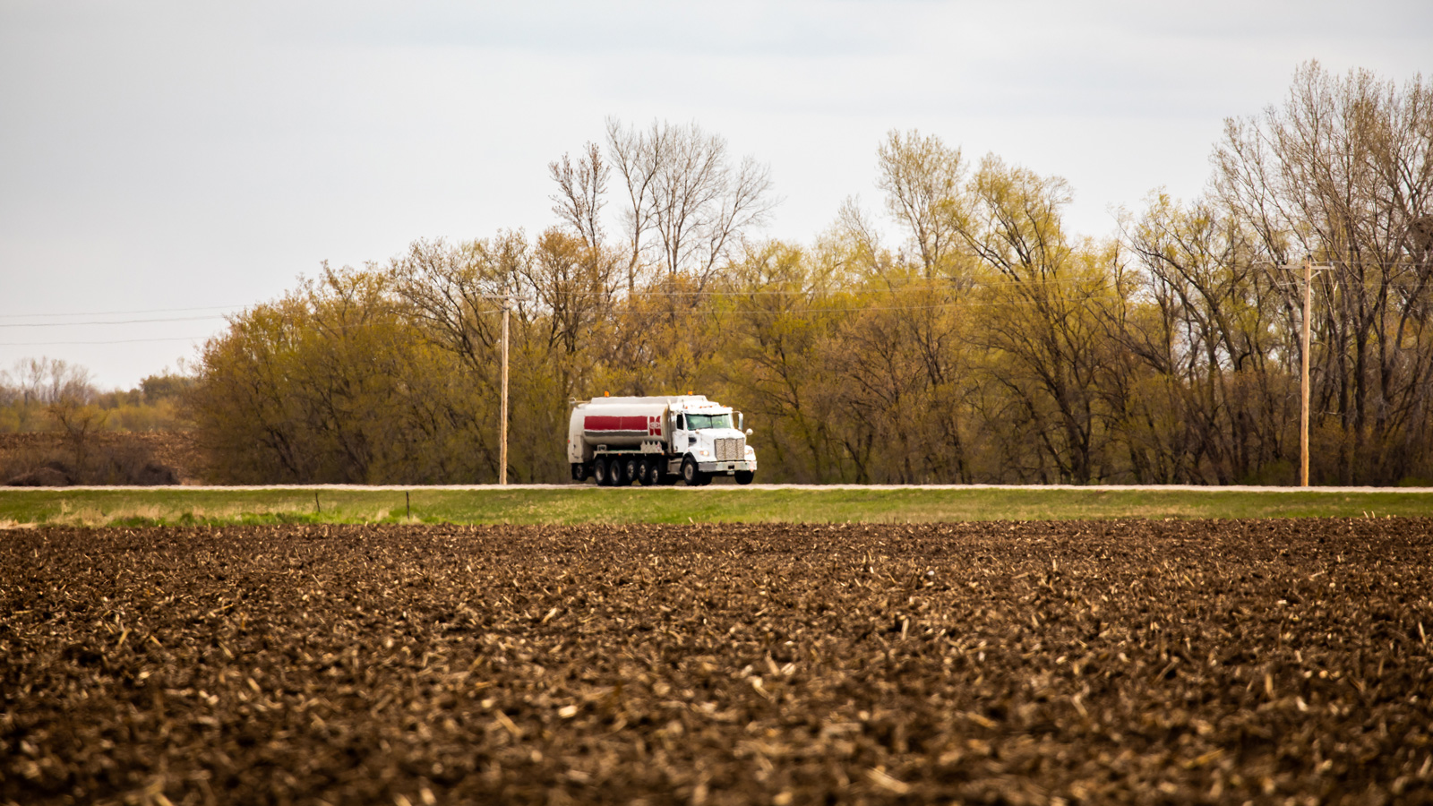 Cenex refined fuels truck driving down a rural road